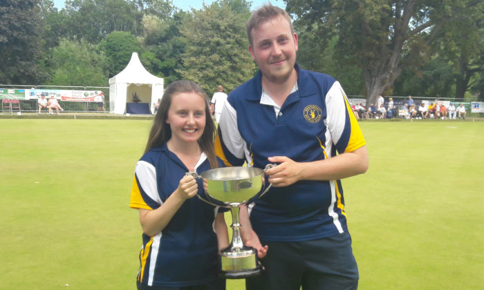 man and woman holding trophy